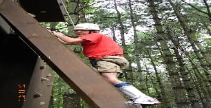 a man climbing a wooden structure