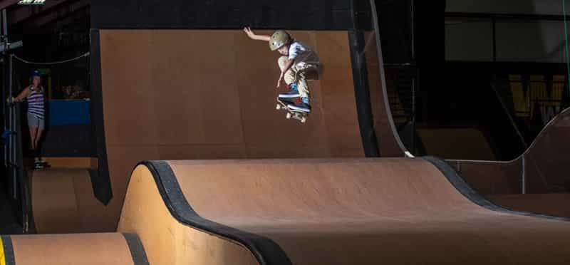 a man riding a skateboard at a skatepark