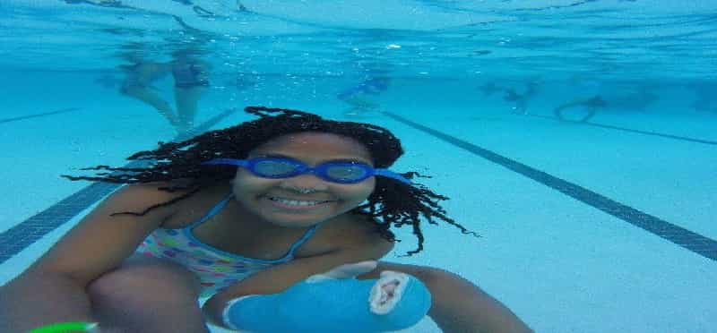 a person in a pool wearing goggles