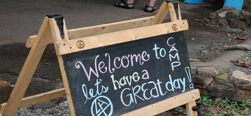 a sign on a wooden bench