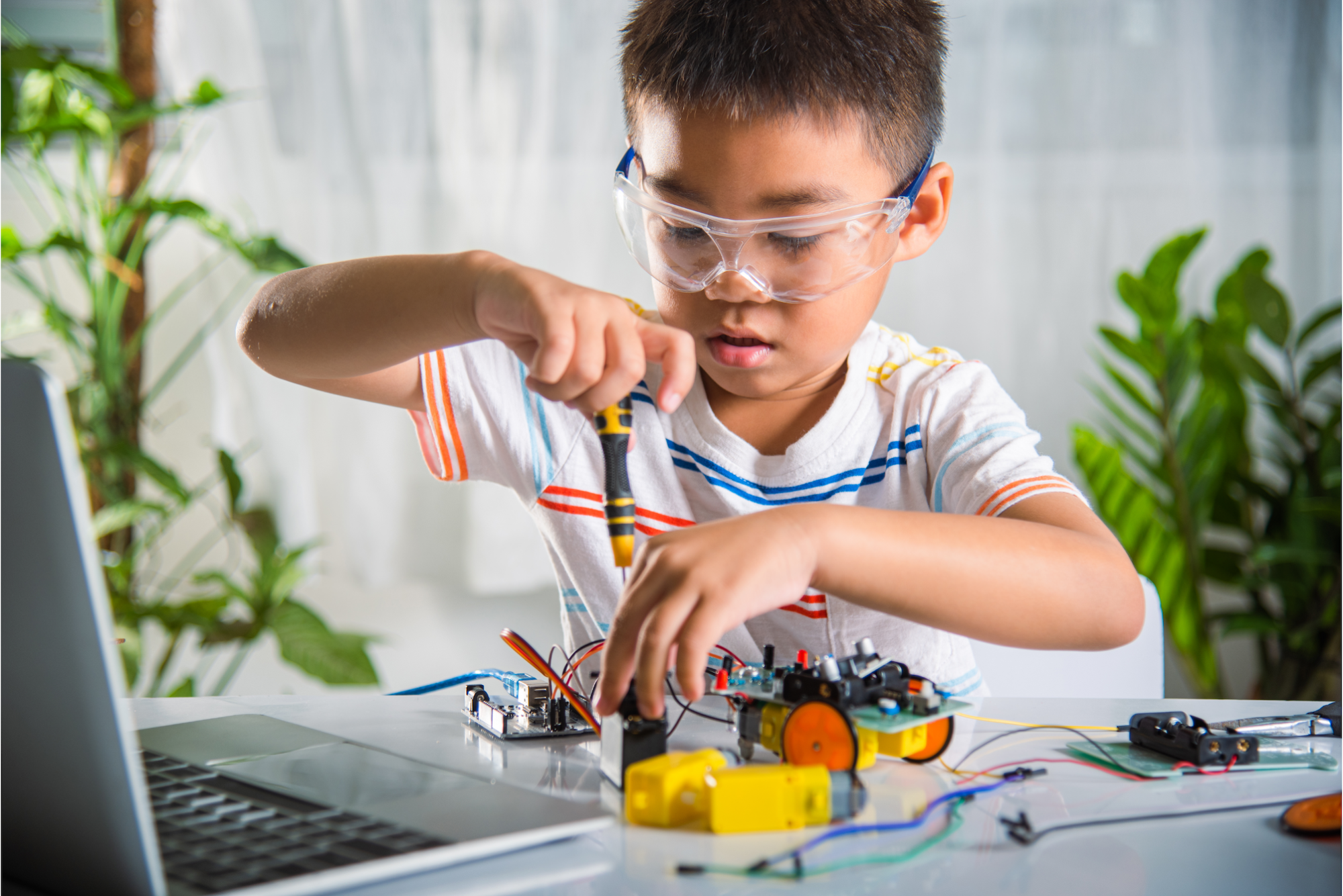 a young boy using a laptop