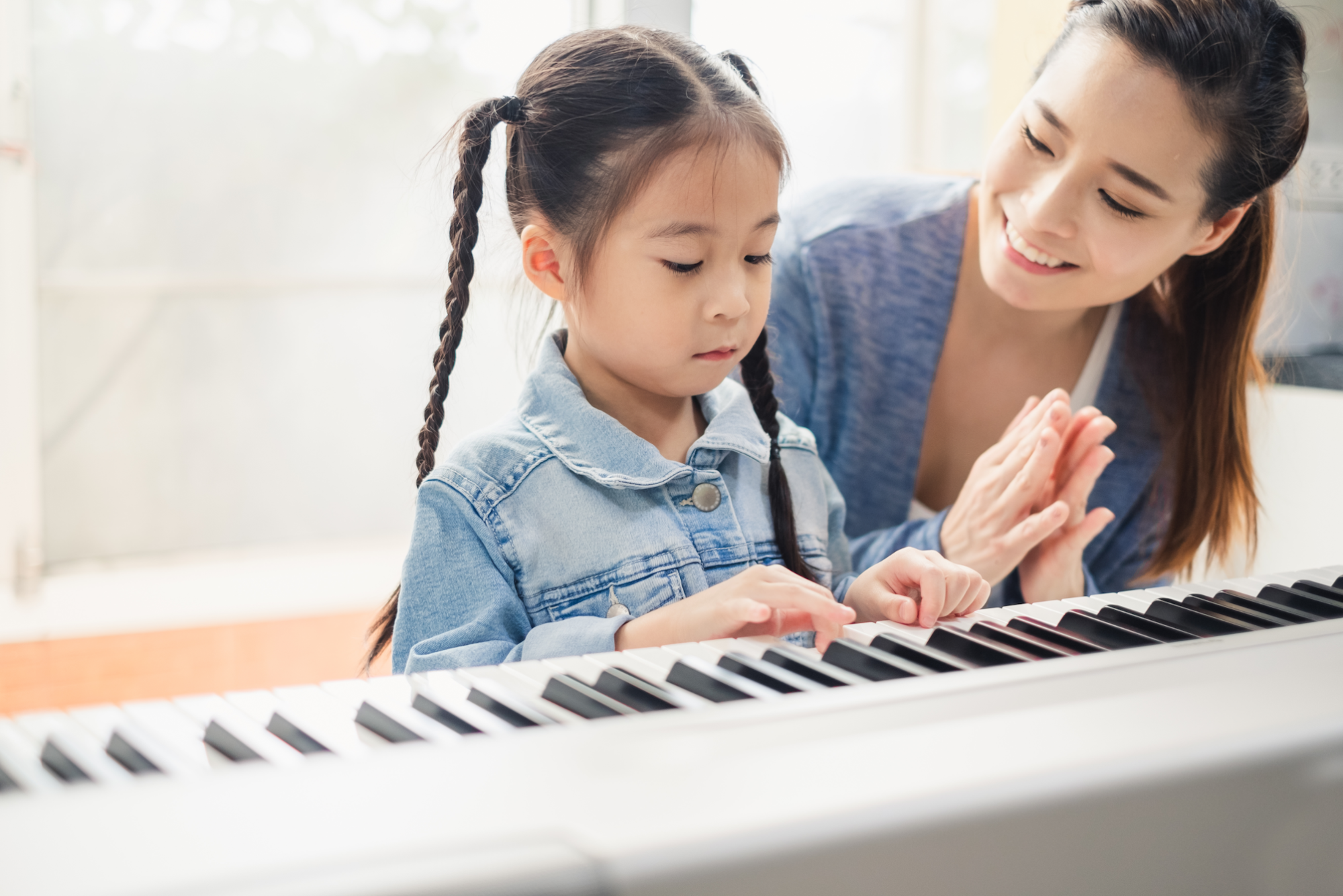 a person and a child looking at a computer screen