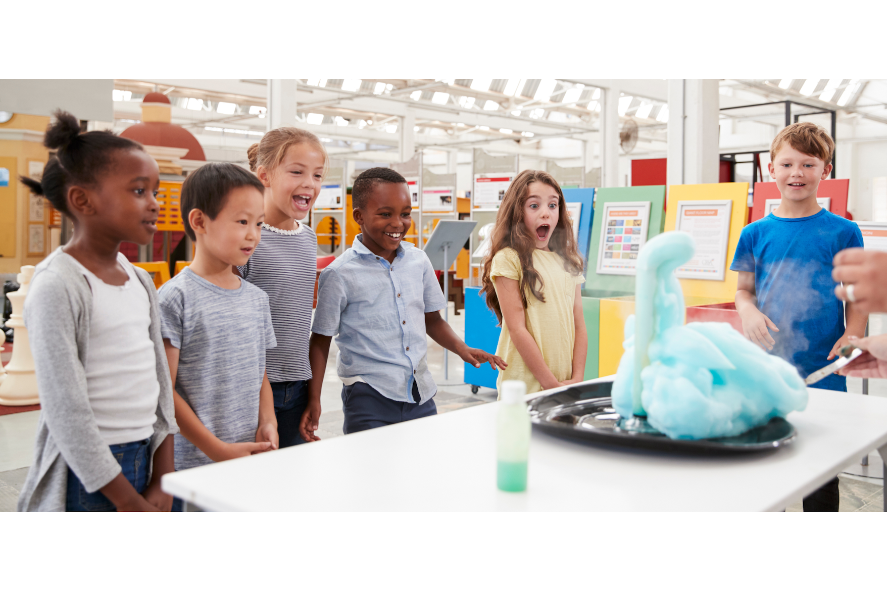 a group of kids looking at a computer screen