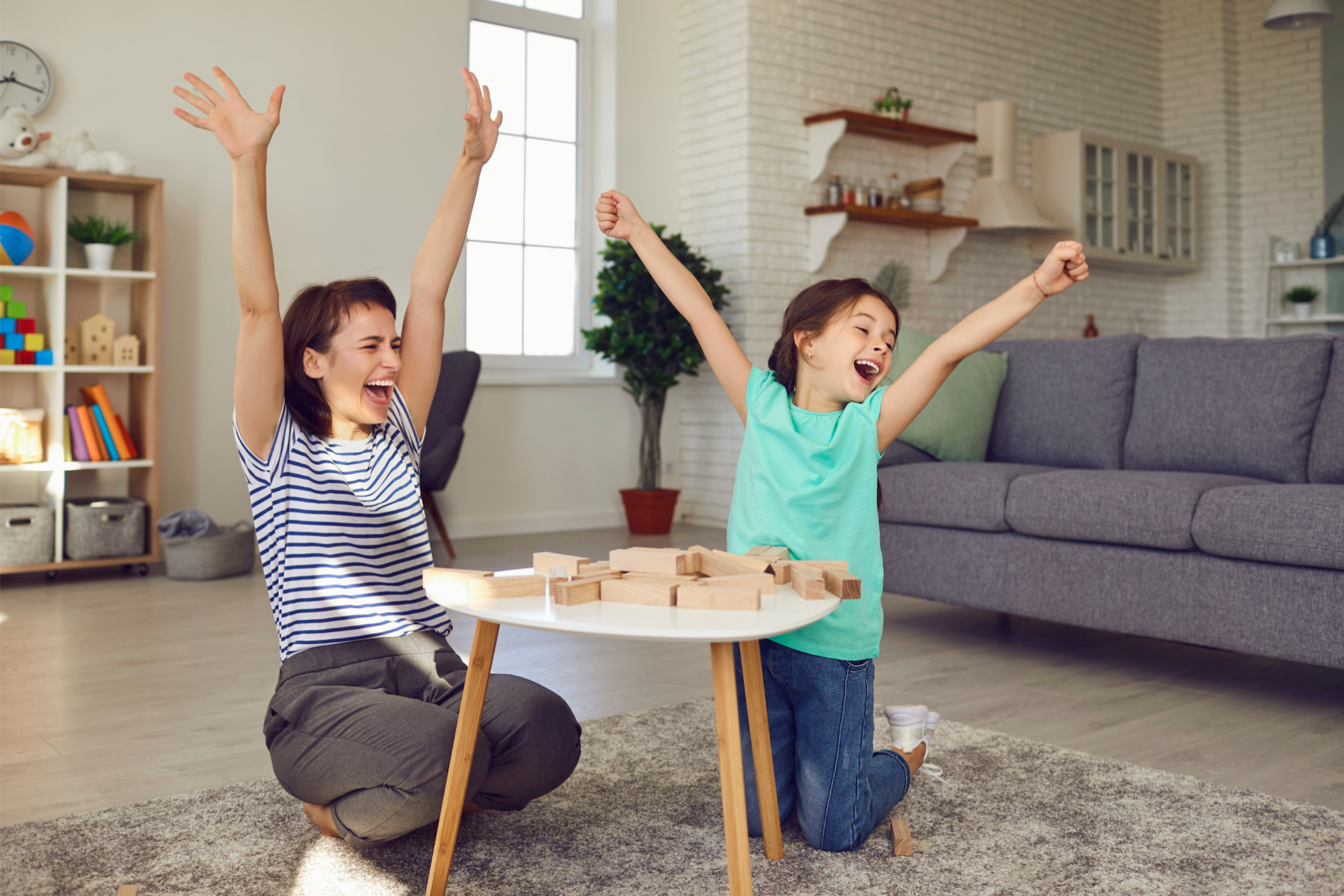 a couple of girls playing with sticks in a living room