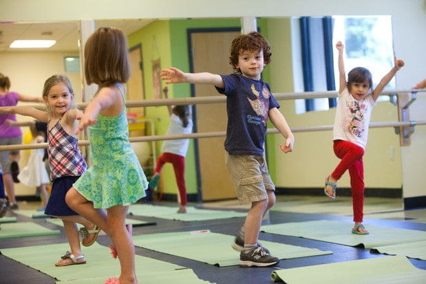 children dancing in a classroom
