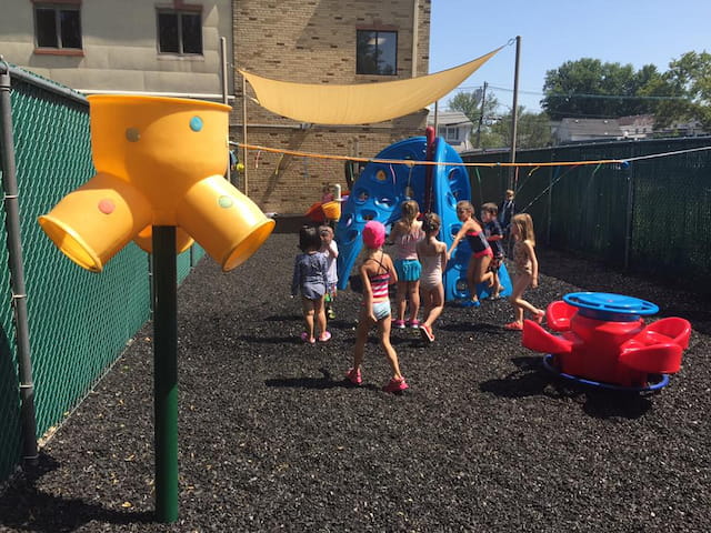 a group of children playing on a playground