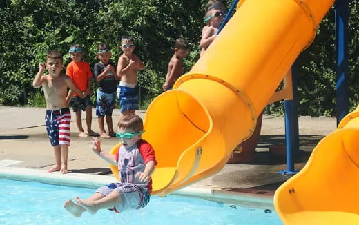 a group of kids playing in a water park