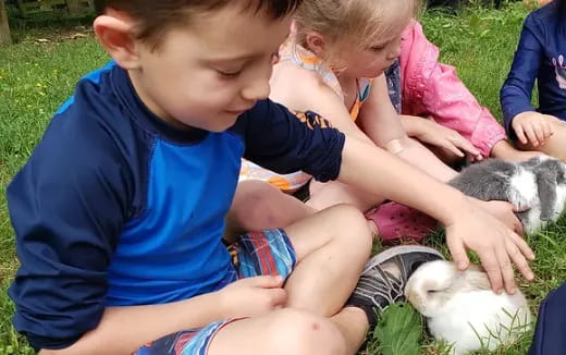 a group of children playing with rabbits