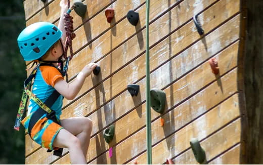 a girl climbing a rock wall