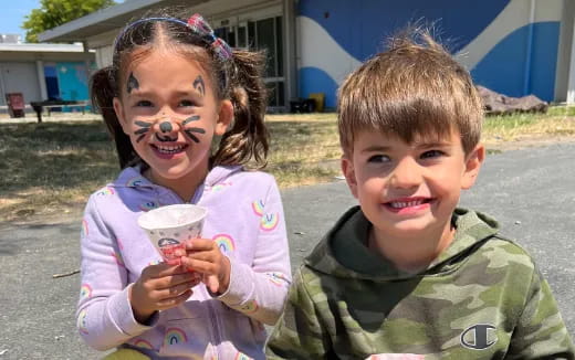 a couple of children smiling