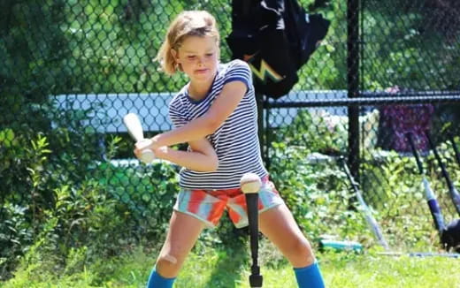 a girl playing baseball
