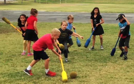 a group of kids playing with sticks