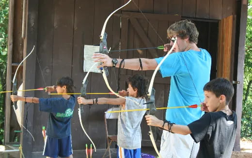 a person holding a rope to a group of boys