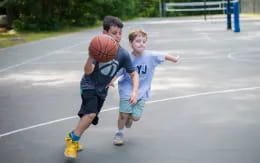 a couple of boys playing basketball