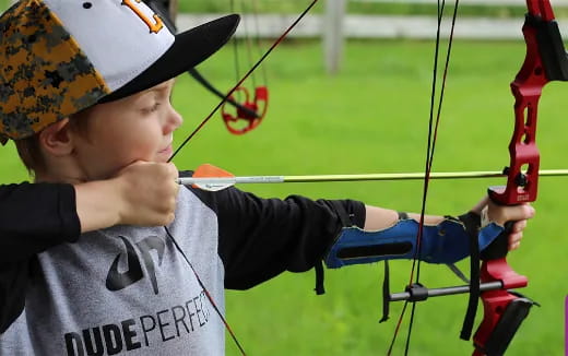 a boy shooting a bow