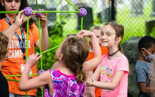 a group of children playing with balloons