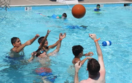 a group of people playing in a pool
