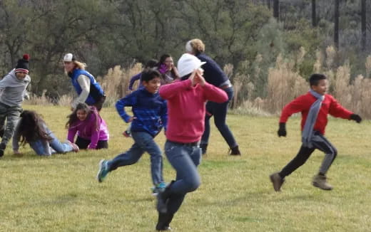 a group of people playing in a field
