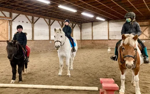 a group of people riding horses