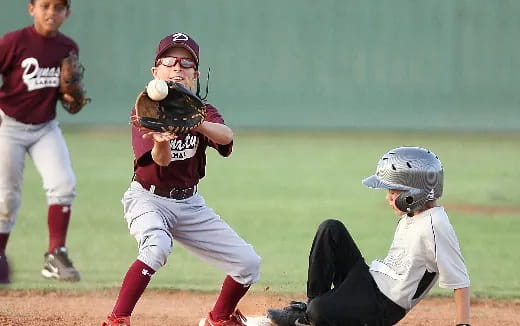 a kid catching a baseball