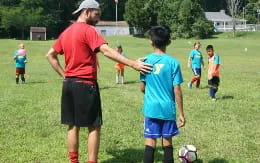 a person and a boy playing football