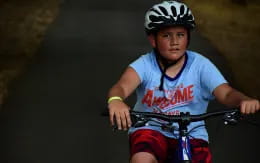 a young boy riding a bike