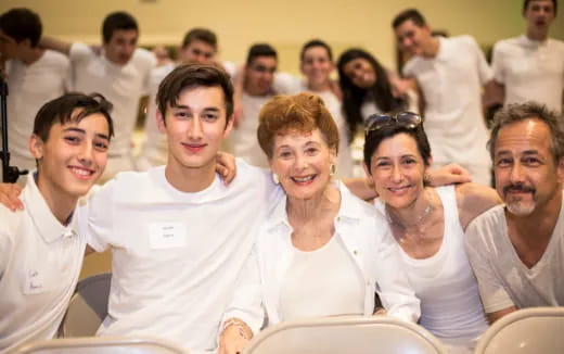 a group of people sitting together smiling