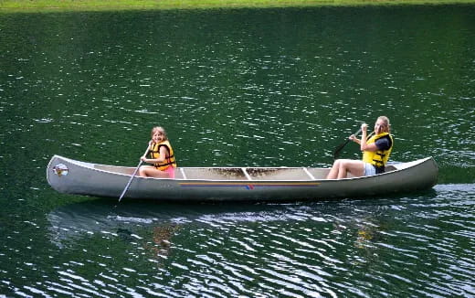 a couple of people in a canoe