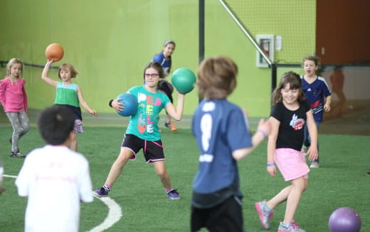 a group of kids playing with balls