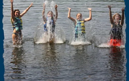 a group of girls jumping in the water