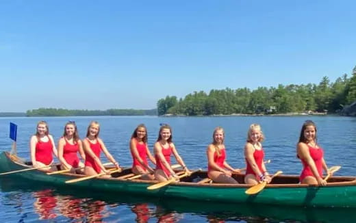 a group of girls in a canoe