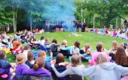 a group of people sitting in a stadium watching a band play