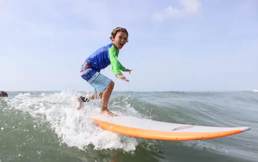 a boy riding a surfboard