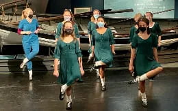 a group of women in blue dresses