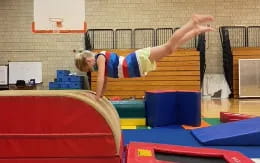 a person doing a backflip on a trampoline