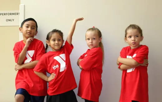 a group of children in red shirts