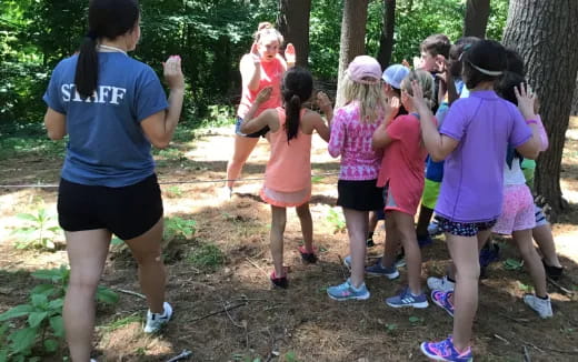 a group of people standing around a tree