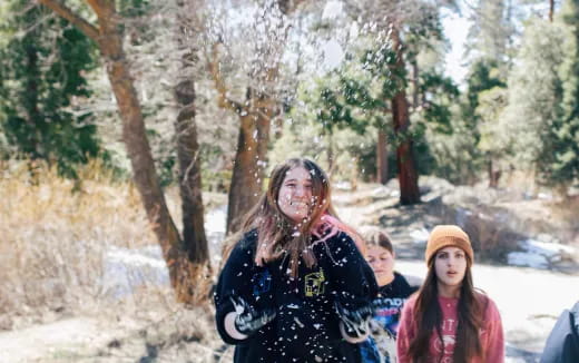 a group of people walking in the woods