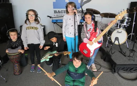 a group of kids holding instruments
