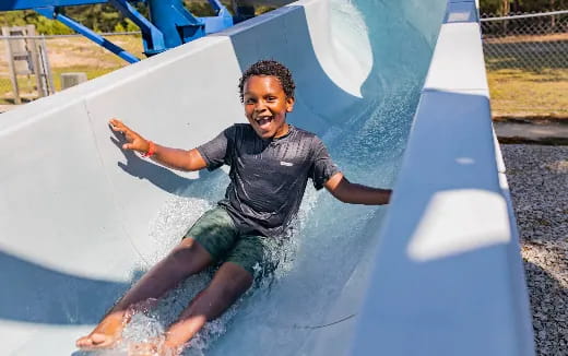 a boy in a water slide