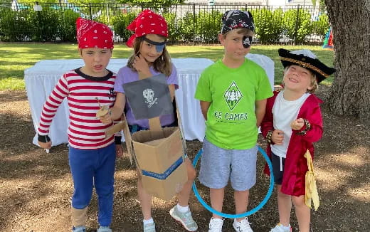 a group of children holding buckets