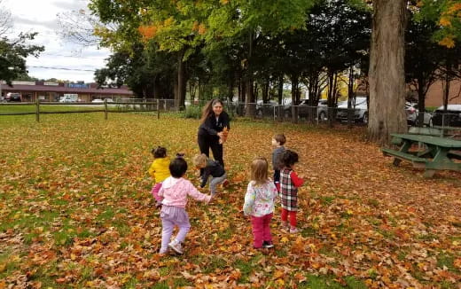 a person and several children in a park