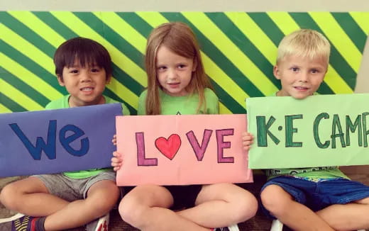 a group of children holding signs