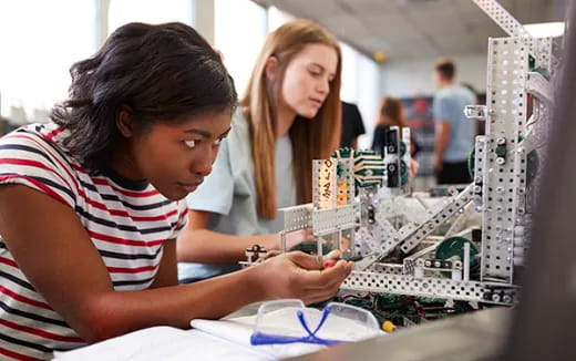 a few young women working at a table