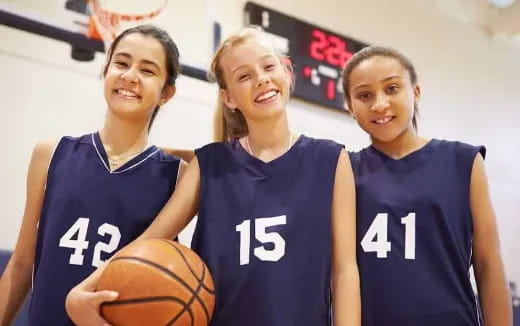 a group of girls in basketball uniforms