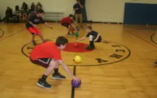 a group of kids playing basketball