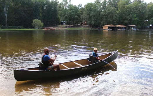 a group of people in a canoe on a lake