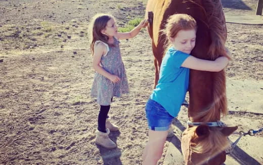 a girl and a girl on a horse