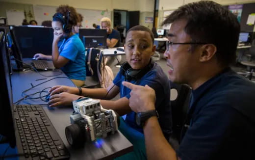 a group of people working on computers