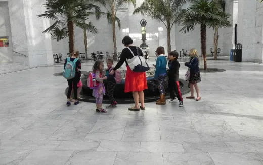 a group of people standing on a sidewalk